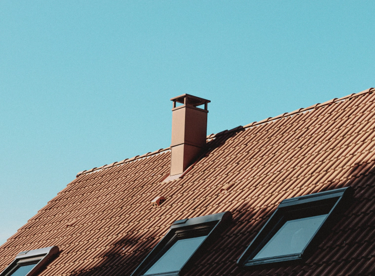light brown roofing with three windows and a light brown chimney